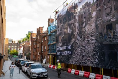 Activists unfurl huge banner depicting suffering in Gaza outside London Labour HQ with message of support for Palestine Action