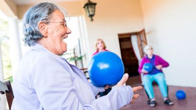 Build strength and improve balance with just a chair and a Pilates ball