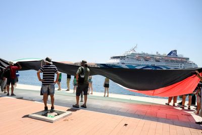 Protesters stop Israeli cruise ship from docking at holiday island