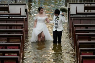 Couple wades through knee-deep water to marry in flooded church as Typhoon Wipha lashes Philippines: ‘It’s a test’