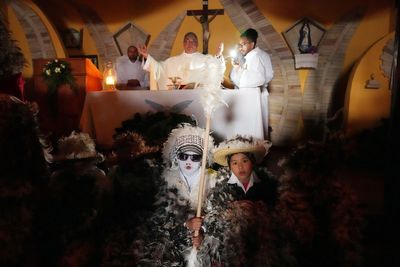 Despite rainy weather, Catholics in a Paraguayan town dress as birds to honor their patron saint