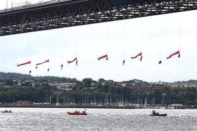Forth Road Bridge closed as 10 Greenpeace activists abseil under it with flags
