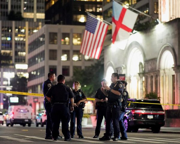 Tributes paid to police officer after gunman kills four in shooting at Manhattan skyscraper – US politics live