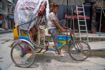 A rickshaw driver and his dog win the hearts of tourists in Nepal