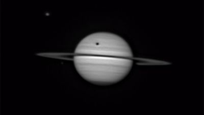 Saturn's largest moon Titan casts a colossal shadow in breathtaking amateur portrait (photo)