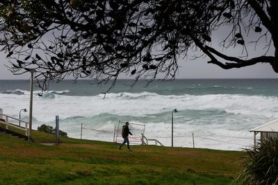 Residents warned of potential ‘major flooding’ and damaging surf in NSW after wild weekend weather