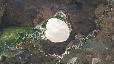 Lake-filled impact crater in Africa transforms into a giant silver 'mirror' via rare phenomenon — Earth from space