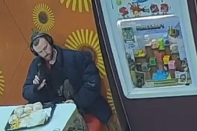 Moment man brandishes gun at teens in McDonald’s before aiming it at police