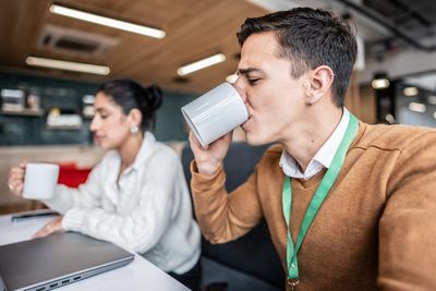 Millennials lead the ‘coffee badging’ revolt to protest return to office as businesses push to fill empty seats