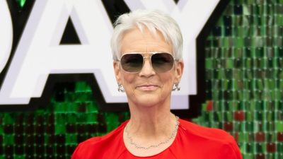 Jamie Lee Curtis proves you can never go wrong with red in a striking midi cape dress for the Freakier Friday premiere
