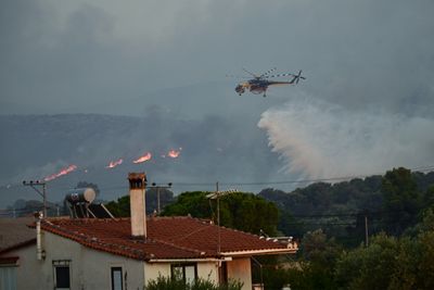 At least one killed as firefighters battle Greece blaze for second day