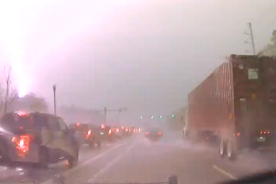 Bolt of lighting hits transformer by busy highway causing huge fireball in dramatic footage