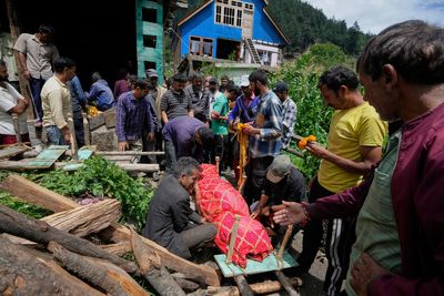 Photos of mourners and searches for the missing from flash floods in Pakistan and India