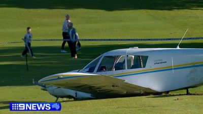 Light plane crash lands on suburban golf course
