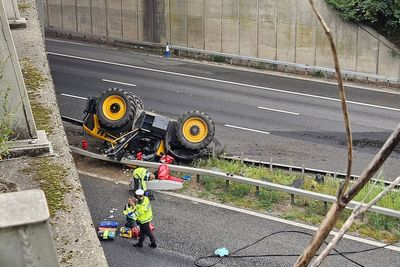 Man seriously injured after tractor falls onto motorway from bridge
