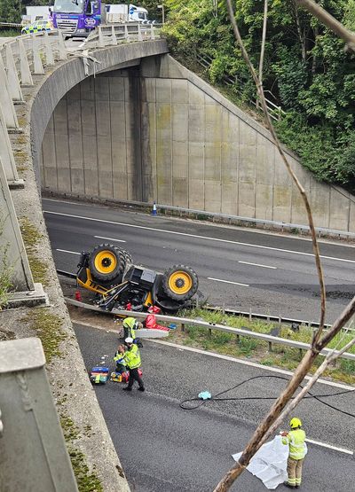 Tractor falls from bridge onto M20 motorway outside London leaving man seriously hurt