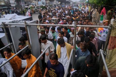 Photos of Pakistan honoring a Sufi saint with drumming, dancing, and bright lights