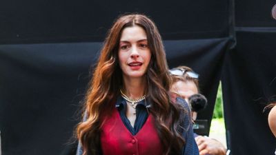 Anne Hathaway confirms knee-high boots paired with a maxi dress as the go-to outfit formula for the season ahead