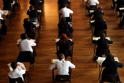Top GCSE grades rise but key pass rate falls