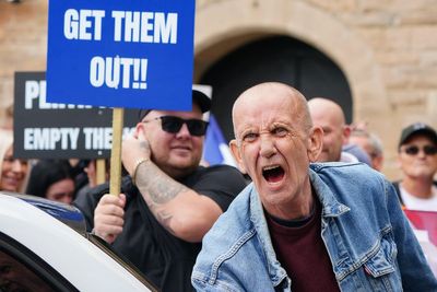 Opposing sides chant and shout outside asylum hotel in Perth