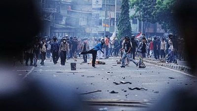 Riot police and students clash during protest against MPs' allowances in Jakarta