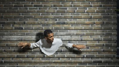 Why can't we walk through walls if atoms are mostly empty space?