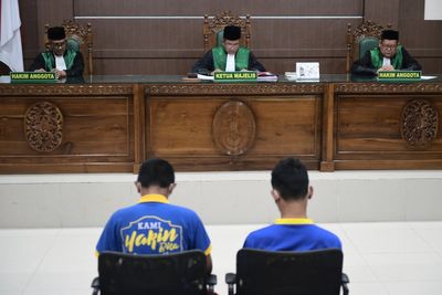 Men charged with hugging and kissing are among group publicly caned by Indonesian Islamic court