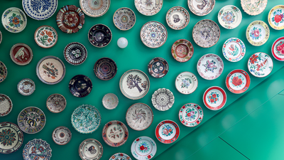Well, That's Something New — This Designer Put the Homeowner's 100+ Piece Ceramic Collection Across the Ceiling of Their Tiny Apartment's Kitchen