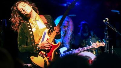 “My guitar was slightly out.Steve Vai walked past and said,‘Your low E was four cents flat.’And he’d been in the green room!” Meet Derek Day, the swaggering virtuoso who went from busking on the streets to touring with his hero