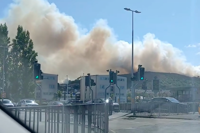 Thick smoke fills sky as fire breaks out on mountain