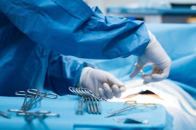 Doctor who posted image of himself performing brain surgery on dating website struck off