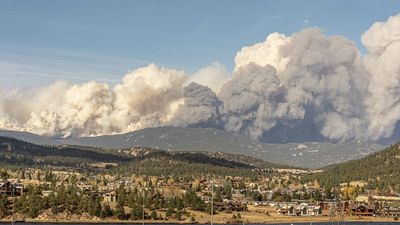 Colorado wildfire now one of largest in state history, but officials say rainfall – and increased flash flood risk – is on the way