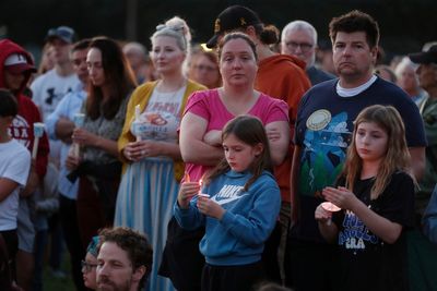 Hundreds honor 2 children killed and 17 people wounded in shooting at a Minneapolis Catholic school