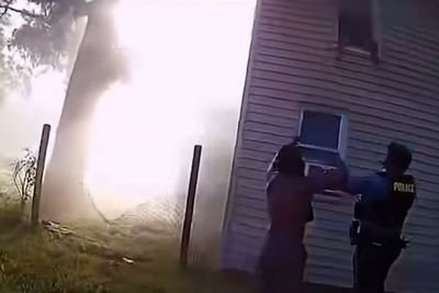 Heart-stopping moment police catch child jumping from window of burning house