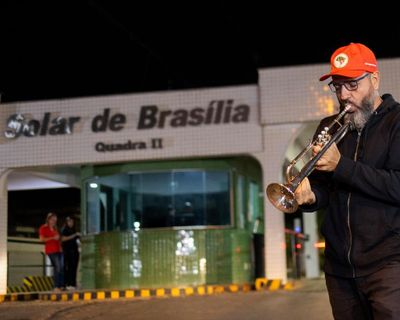 ‘I’m holding his political wake’: the trumpeter waiting to mark Bolsonaro’s judgment day
