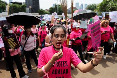 Why women dressed in pink and armed with brooms are joining Jakarta protests
