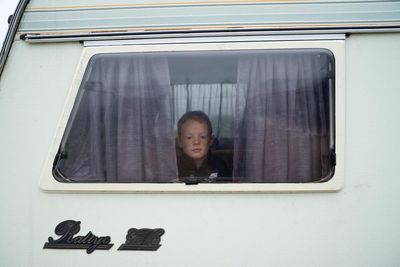 A boy contemplates life from a caravan window: Nik Roche’s best photograph