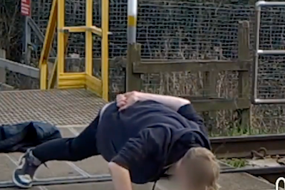 Youth caught on CCTV doing pushups on level crossing