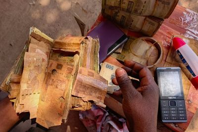 A rebel-held Congolese city uses damaged banknotes due to a cash shortage