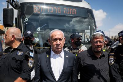 At least six killed and 12 injured after gunmen open fire at bus stop in Jerusalem