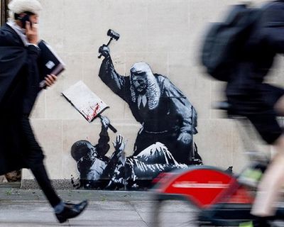 Court staff cover up Banksy image of judge beating a protester