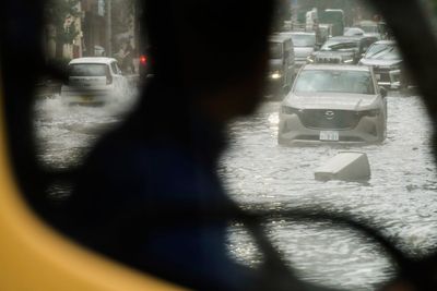 Sudden deluge of rain floods some streets and halts air and rail traffic in Tokyo