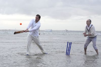 In Pictures: Waterlogged pitch perfect for cricketers playing annual game in sea