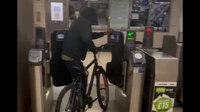 Moment fare dodger pushes bike through ticket barrier at London's Bank Station