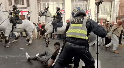 Dramatic moment police drag unconscious man to safety after he collapses at Tommy Robinson march