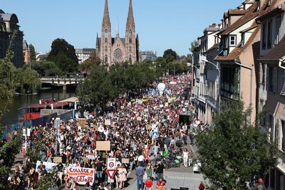 Macron feels the heat as French workers protest his budget cuts
