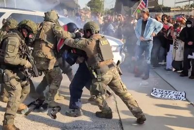 Protester with Captain America shield bundled into ICE facility in Chicago after throwing back tear gas canister
