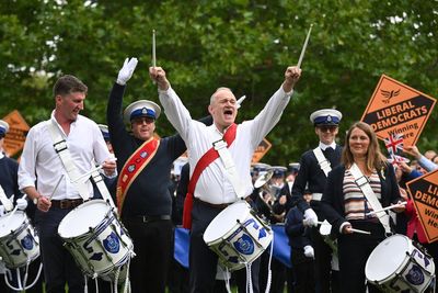 Ed Davey kicks off Lib Dem conference twirling a baton in marching band