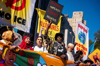 Photos show activists targeting billionaires in a street protest on the eve of New York Climate Week