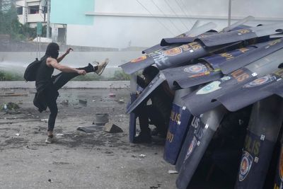 Philippine police arrested dozens after a violent clash near presidential palace, in photos